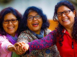 In this March 1, 2014 photo, from left, Lucky, Dicky, and Nicky Chettri pose for photographs at the 3 Sisters Adventure Trekking Company office in Pokhara, Nepal. When Lucky, Dicky and Nicky Chettri tried to break into Nepal's male-dominated trekking industry 20 years ago, competitors tried to run them out of business. Men threatened them, harassed them - even filed bogus police reports against them. (AP Photo/Niranjan Shrestha)