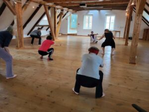NIA-Tanzen mit Parkinson - Frau unten rechts im Bild hockend
